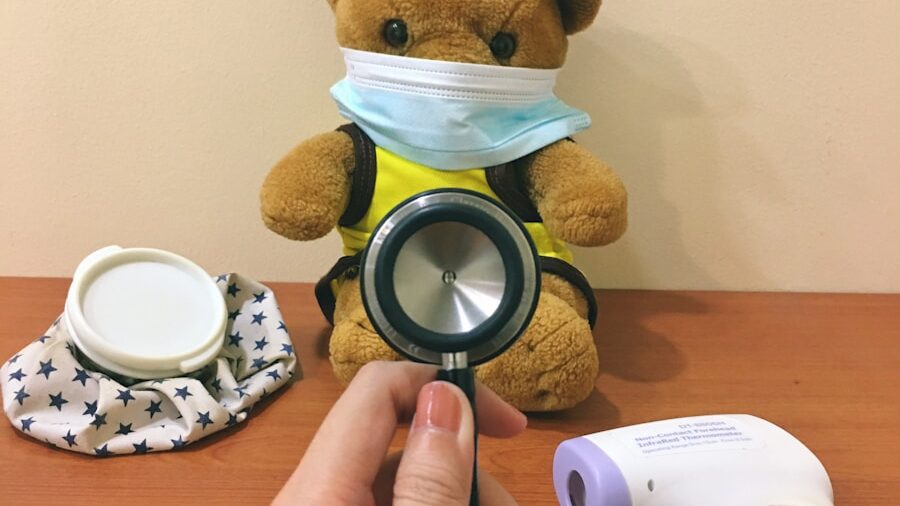 brown bear plush toy beside white and black round frame
